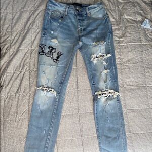 AMIRI Blue Skinny Black Patch/Writing Distressed Jeans